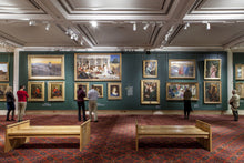 Load image into Gallery viewer, Art gallery with visitors and framed paintings on the walls.
